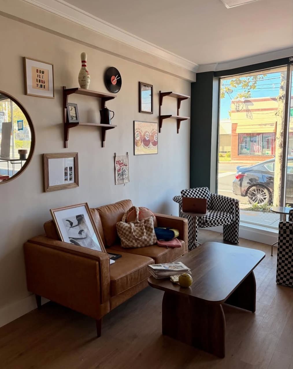 The seating area with checkered chairs beside the front window, looking out onto the street